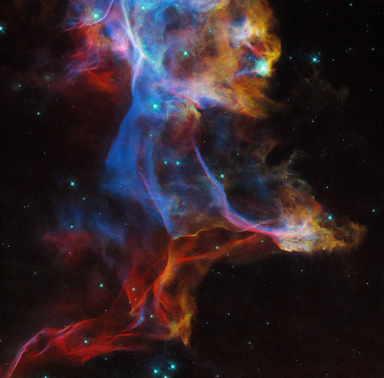 A mesmerizing image from the NASA/ESA Hubble Space Telescope reveals the Veil Nebula, a breathtaking remnant of a stellar explosion. Swirling hues of blue, red, and yellow trace the glow of different atoms within the hot gas, painting a vivid portrait of this cosmic phenomenon. Image Credit: ESA/Hubble & NASA, R. Sankrit.